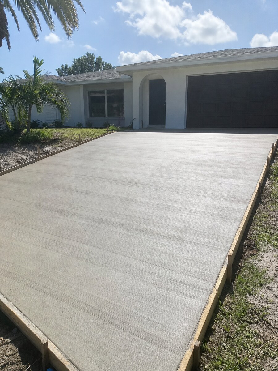 Freshly poured and broom-finished concrete driveway at a Jensen Beach home
