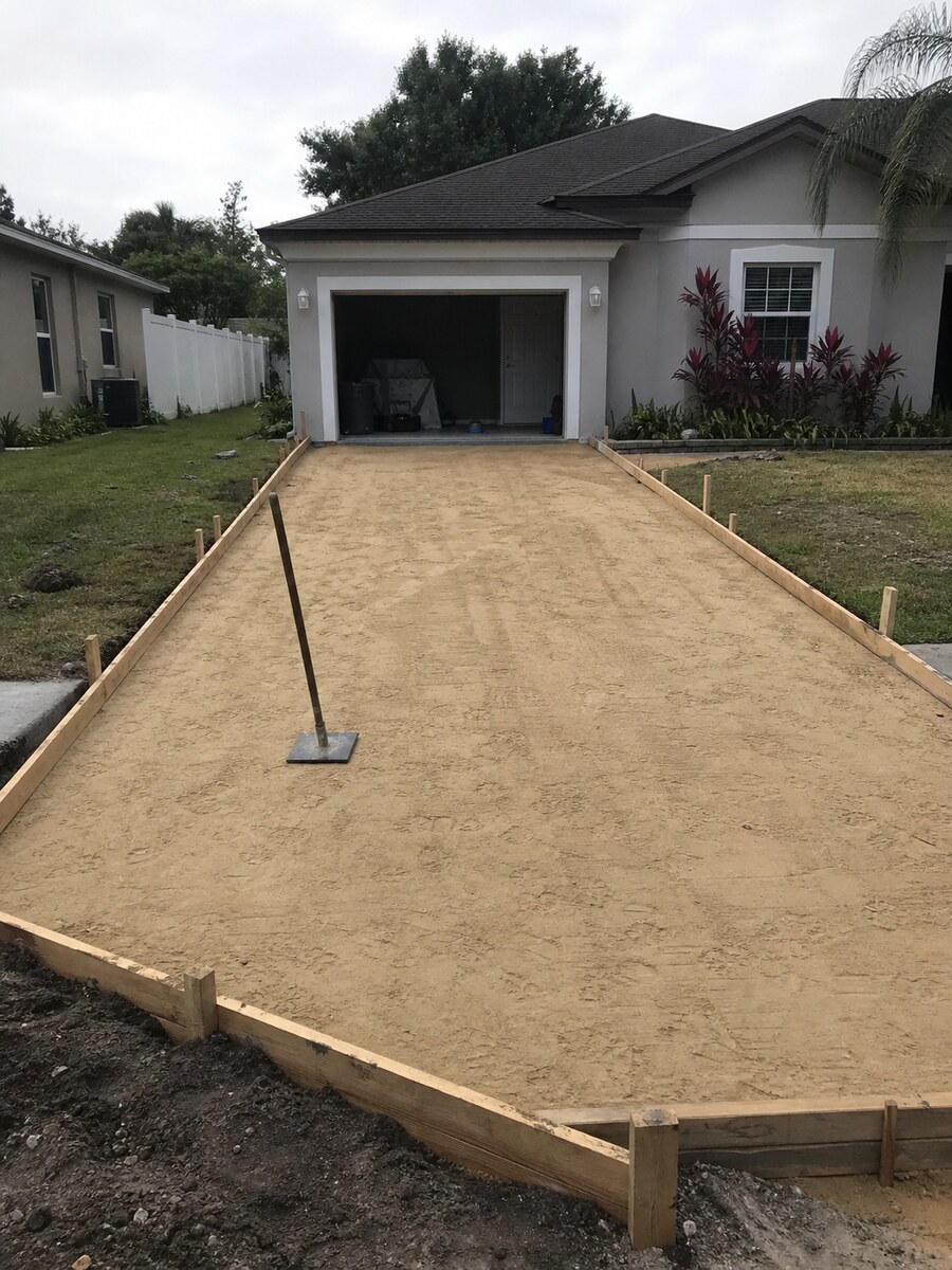 Wood forms and compacted base prepared for a concrete driveway pour in Jensen Beach