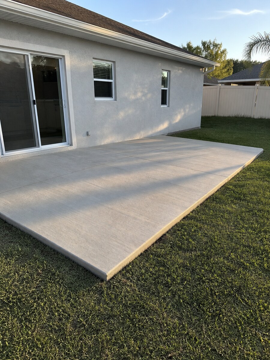 Finished broom-textured concrete patio behind a Martin County home